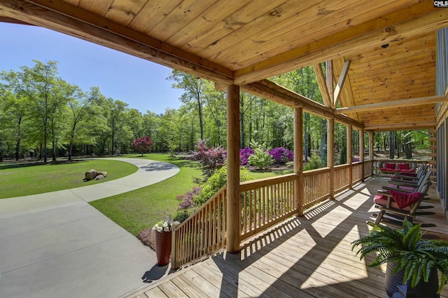 wooden deck with a lawn