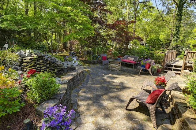 view of patio / terrace featuring a fire pit and a deck