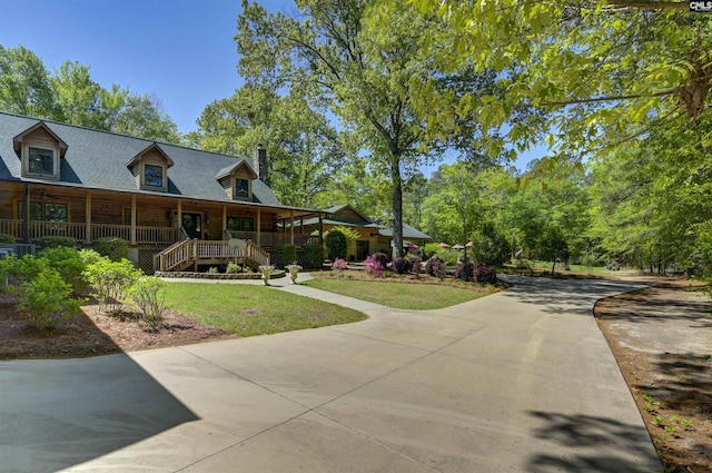 exterior space featuring driveway and a yard