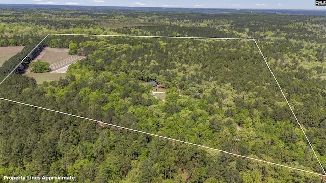 birds eye view of property with a view of trees