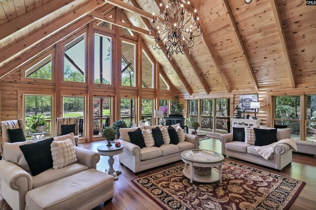 living area with beamed ceiling, a wealth of natural light, and wood ceiling