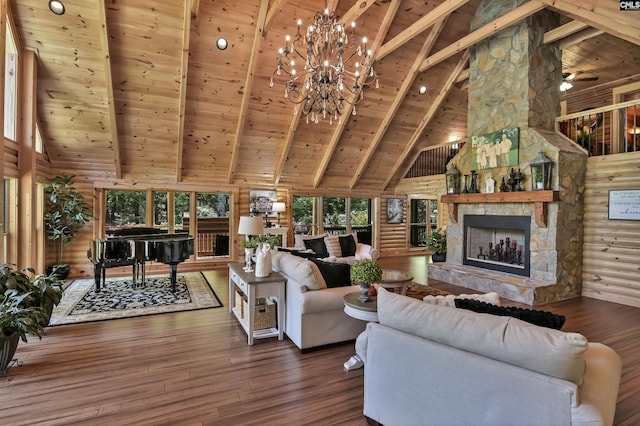 living room featuring beamed ceiling, a stone fireplace, high vaulted ceiling, and wooden ceiling