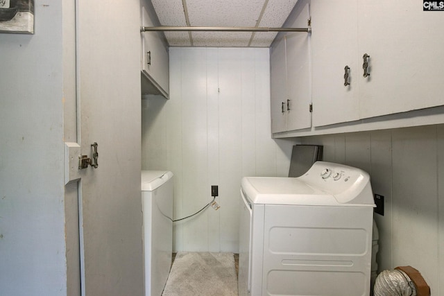 clothes washing area featuring carpet, cabinet space, and independent washer and dryer