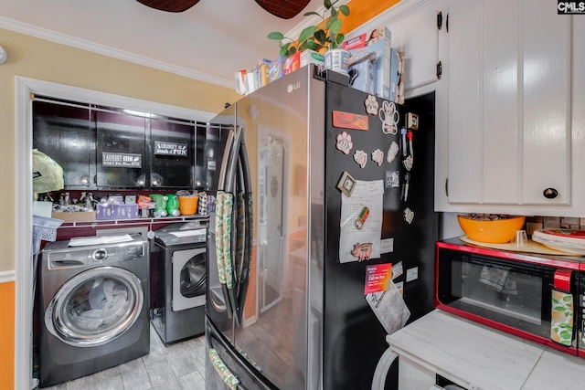 clothes washing area featuring washing machine and dryer and crown molding
