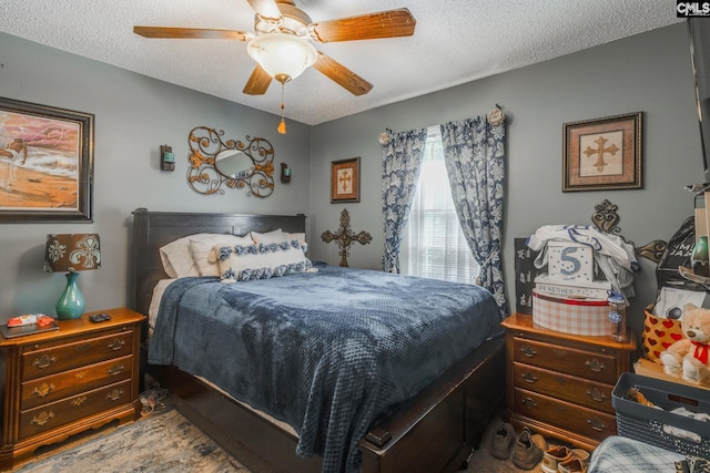 bedroom with a textured ceiling and ceiling fan