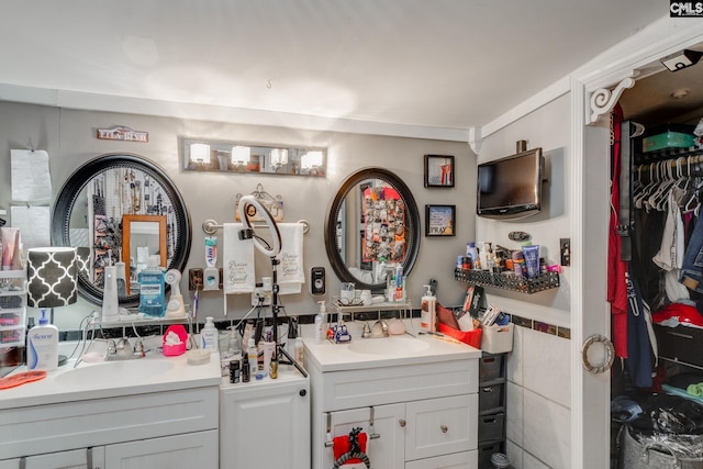 full bathroom with vanity and a walk in closet
