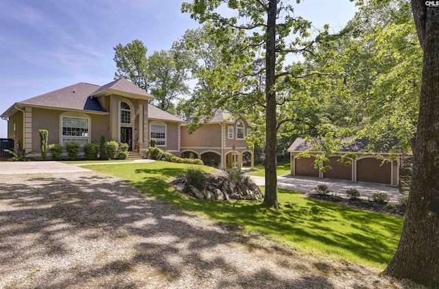 1305 Rock Island Rd, Gilbert, SC 29054 - mediterranean / spanish house featuring an outbuilding, driveway, a garage, a front yard, and stucco siding