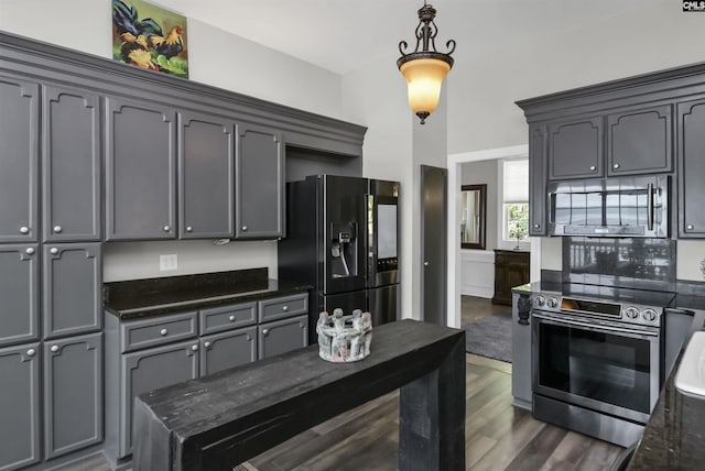 1305 Rock Island Rd, Gilbert, SC 29054 - kitchen with dark stone countertops, pendant lighting, gray cabinetry, appliances with stainless steel finishes, and dark wood-style flooring