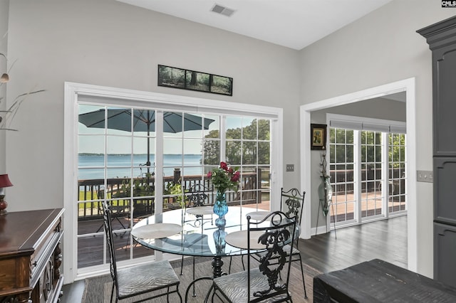 1305 Rock Island Rd, Gilbert, SC 29054 - dining room featuring baseboards, visible vents, dark wood-style floors, and a water view