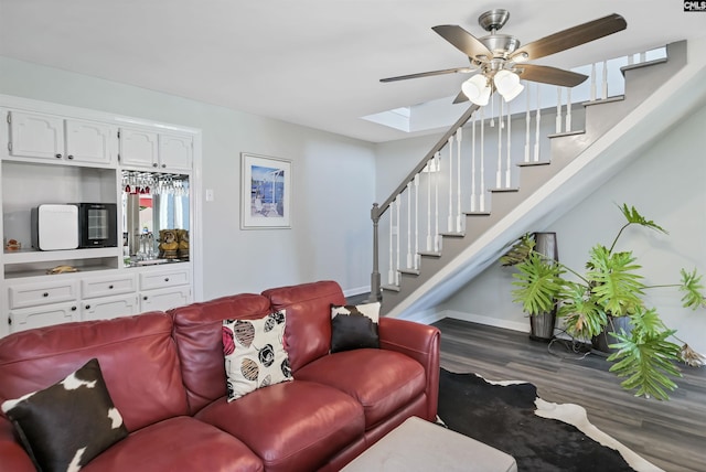 1305 Rock Island Rd, Gilbert, SC 29054 - living room with wood finished floors, a ceiling fan, a skylight, baseboards, and stairs