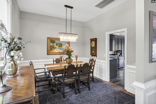 1305 Rock Island Rd, Gilbert, SC 29054 - dining space featuring a decorative wall, wainscoting, a chandelier, dark wood finished floors, and visible vents