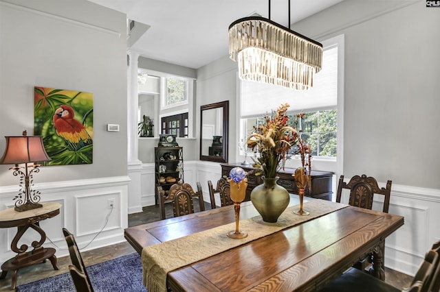 1305 Rock Island Rd, Gilbert, SC 29054 - dining room with an inviting chandelier, a decorative wall, wainscoting, and decorative columns