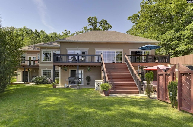 1305 Rock Island Rd, Gilbert, SC 29054 - rear view of house with stucco siding, a lawn, stairs, and a deck