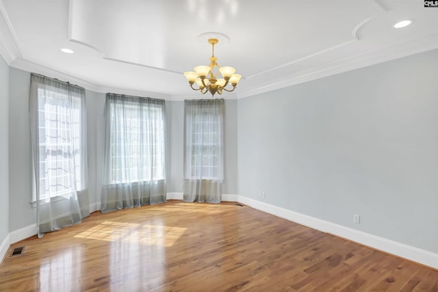 unfurnished room featuring a chandelier, visible vents, baseboards, and ornamental molding