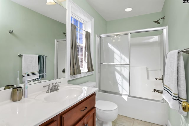 full bathroom featuring toilet, vanity, tile patterned floors, and shower / bath combination with glass door