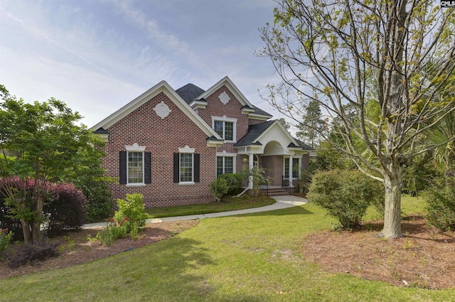view of front facade with a front lawn and brick siding