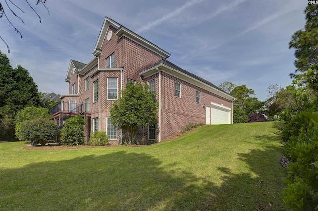 view of side of property with brick siding and a yard