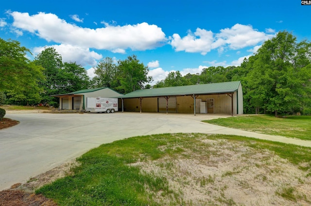 2310 Priceville Rd, Gilbert, SC 29054 - view of front of home with an outbuilding, a front lawn, metal roof, and driveway