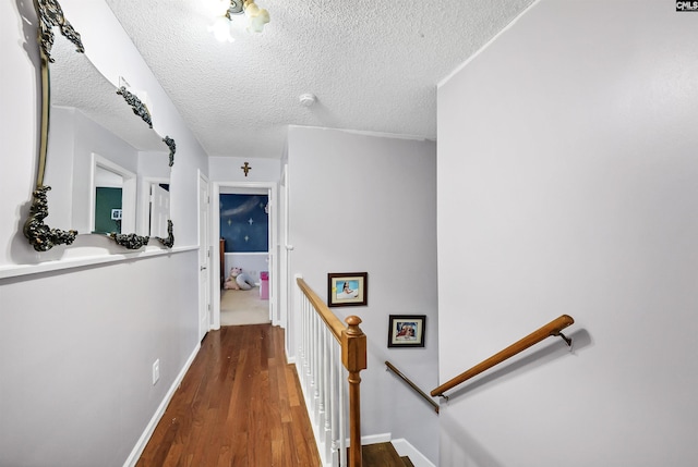 320 Brookshire Dr, Columbia, SC 29210 - corridor with baseboards, wood finished floors, an upstairs landing, and a textured ceiling