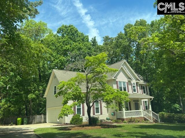 colonial inspired home featuring a front lawn, driveway, an attached garage, fence, and a porch