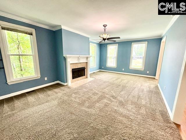 unfurnished living room with ornamental molding, carpet floors, and a ceiling fan