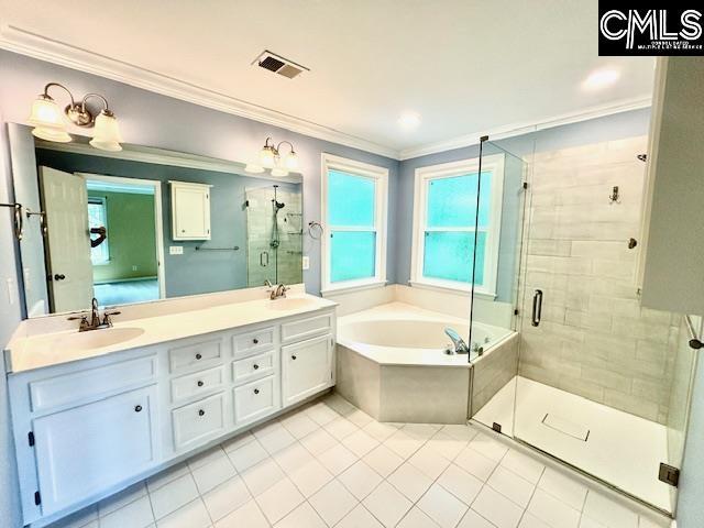 full bath with crown molding, tile patterned flooring, a sink, and visible vents