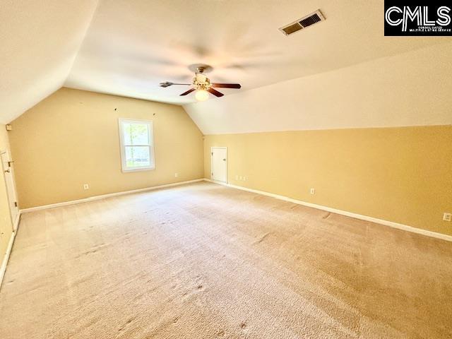 bonus room with vaulted ceiling, visible vents, and baseboards