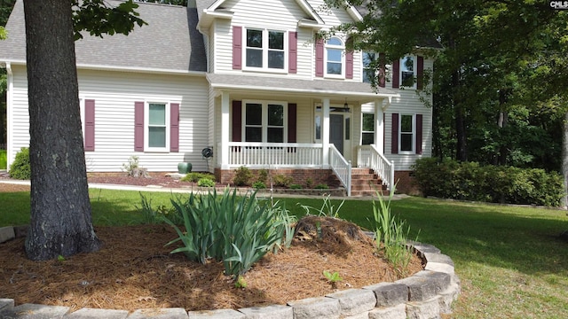 craftsman inspired home featuring a porch, a front yard, and roof with shingles