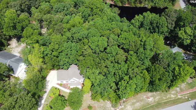 birds eye view of property with a wooded view