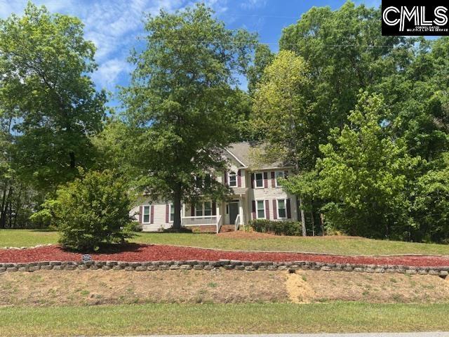 colonial home with a front lawn