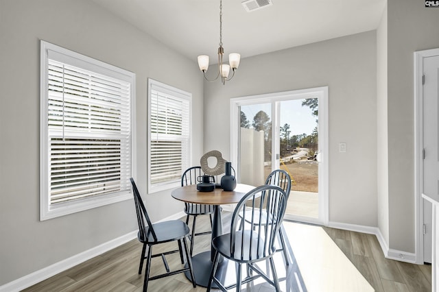 227 Carillo Dr, Columbia, SC 29223 - dining area featuring baseboards, wood finished floors, a chandelier, and visible vents