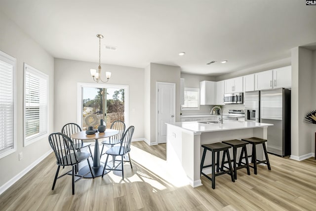 227 Carillo Dr, Columbia, SC 29223 - kitchen with a sink, visible vents, light wood-style floors, a chandelier, and appliances with stainless steel finishes