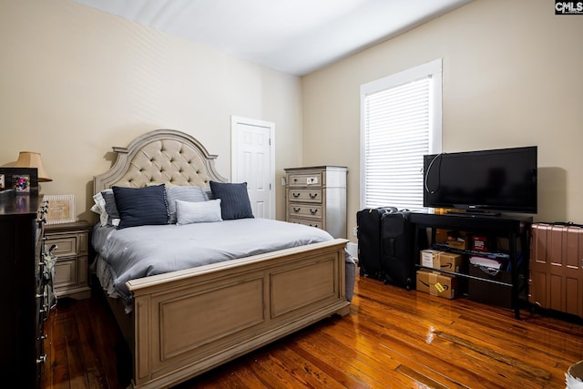 bedroom with dark wood-type flooring