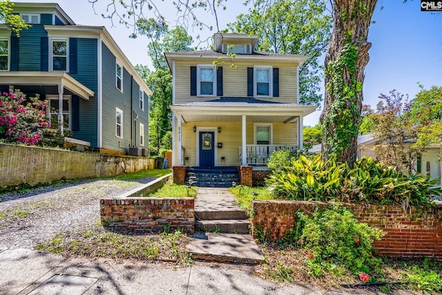 traditional style home with fence, covered porch, and central AC