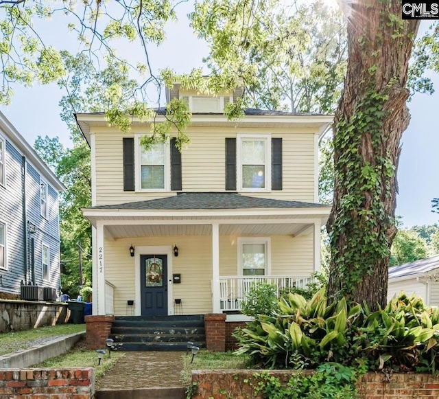 traditional style home featuring covered porch