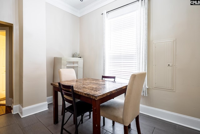 dining area with wood tiled floor, crown molding, and baseboards