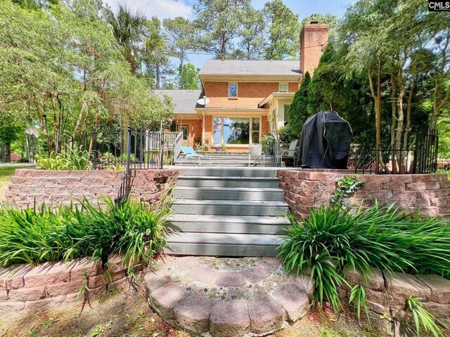 110 Columbia Club Dr, Blythewood, SC 29016 - property entrance featuring brick siding, a chimney, and a deck