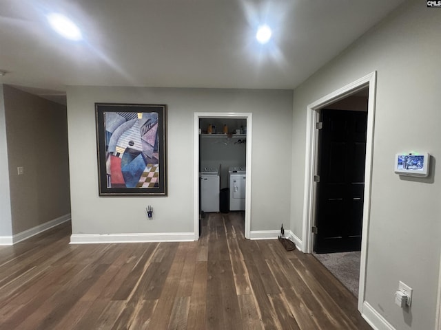 interior space with dark wood finished floors, washing machine and dryer, and baseboards