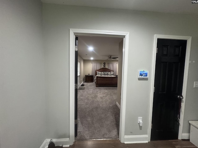 hall featuring baseboards