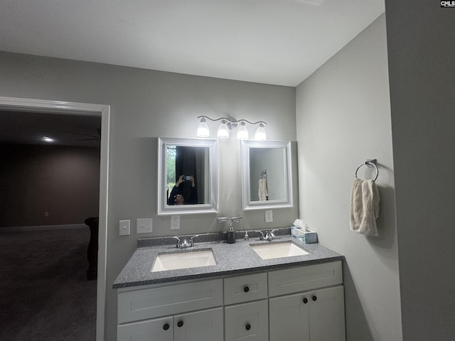 full bath with a sink and double vanity
