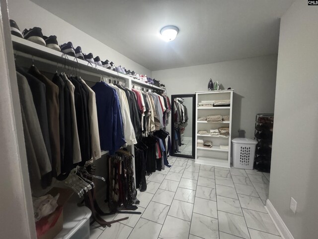 spacious closet featuring marble finish floor