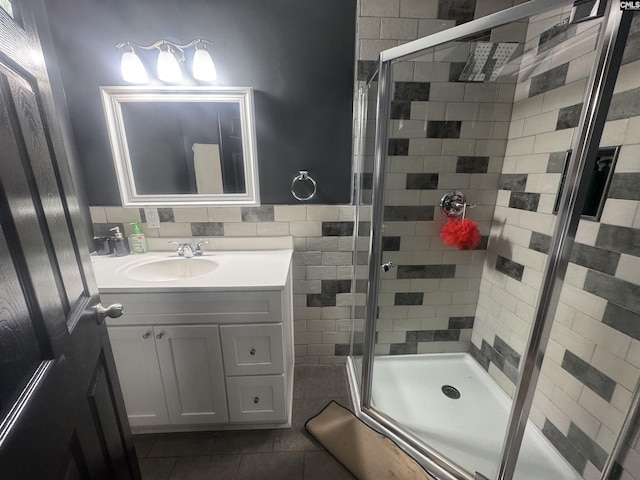 full bath with a shower stall, tile patterned flooring, and vanity