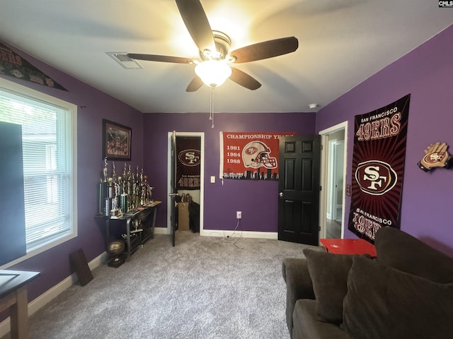 carpeted living area featuring visible vents, a ceiling fan, and baseboards
