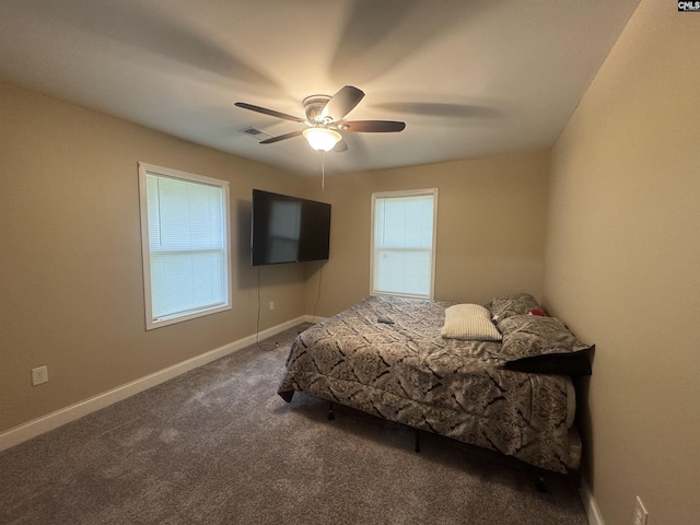 carpeted bedroom featuring baseboards, a ceiling fan, and visible vents
