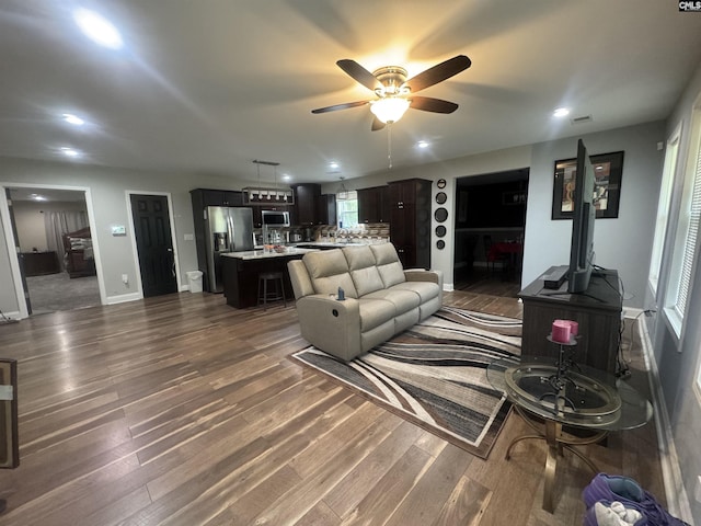 living area featuring recessed lighting, visible vents, dark wood-style flooring, baseboards, and ceiling fan