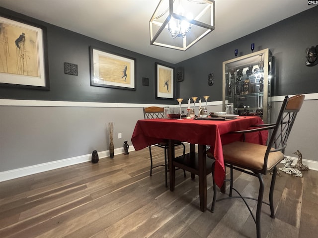 dining area featuring a chandelier and wood finished floors
