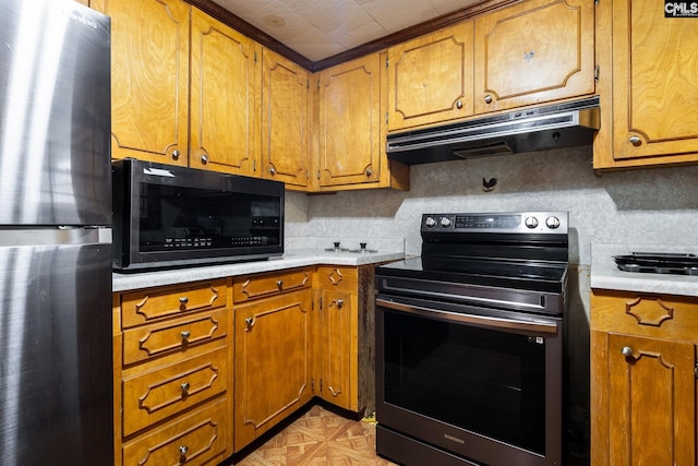1742 Orrs Station Rd, Chester, SC 29706 - kitchen featuring brown cabinets, range with electric cooktop, under cabinet range hood, freestanding refrigerator, and black microwave