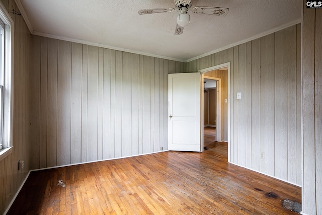 1742 Orrs Station Rd, Chester, SC 29706 - unfurnished room featuring wood walls, crown molding, a textured ceiling, hardwood / wood-style flooring, and ceiling fan