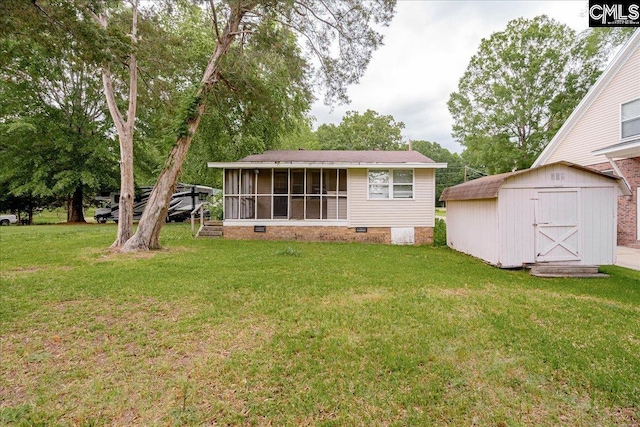 143 Indian Cove Rd, Chapin, SC 29036 - rear view of house with crawl space, a shed, a lawn, an outdoor structure, and a sunroom