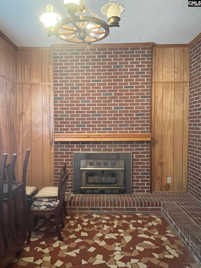 326 Nell St, Batesburg, SC 29006 - living area featuring a textured ceiling, a chandelier, wooden walls, and a fireplace